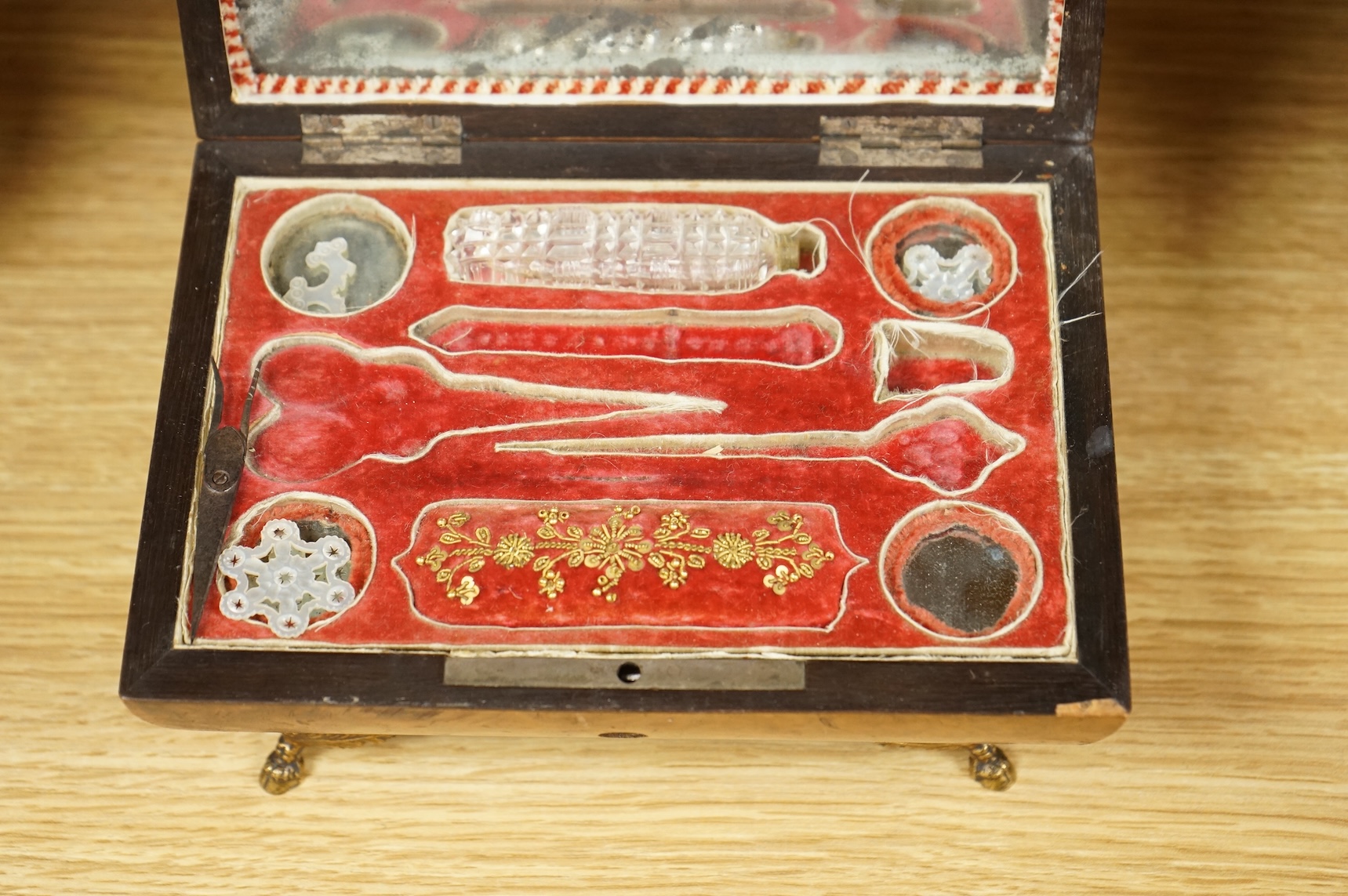 A 19th century burr walnut musical sewing box with mirrored and fitted interior and two silver keys, 18cm wide (mirror cracked)